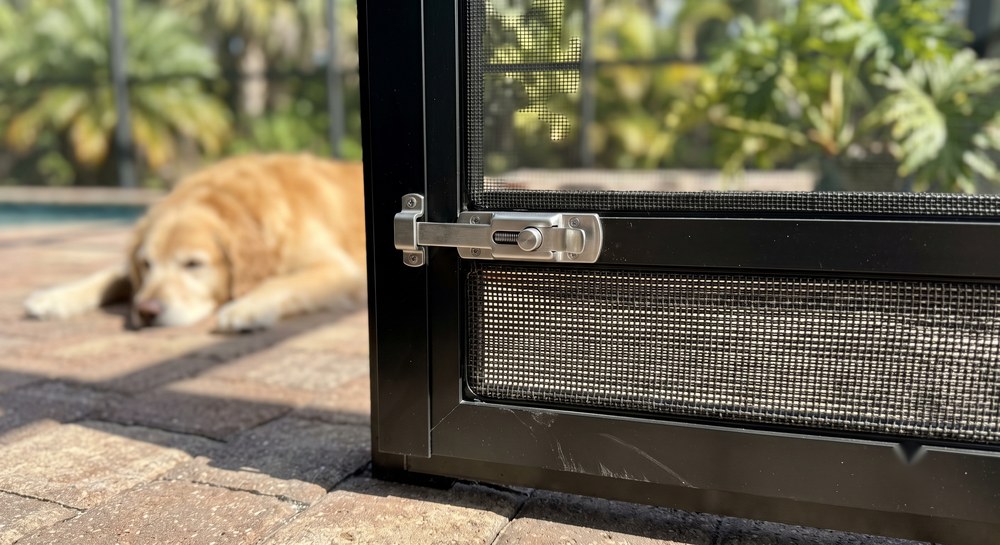 Heavier pet-resistant screen panel on the lower section of a pool cage door in Sarasota, FL